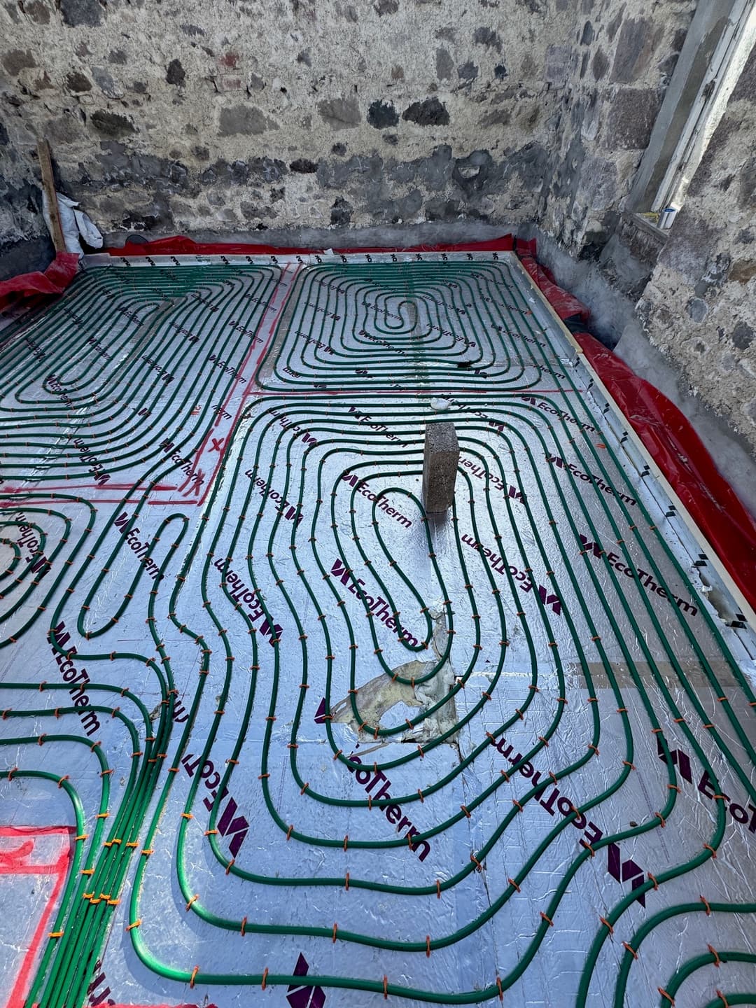 Underfloor heating pipework laid across a floor