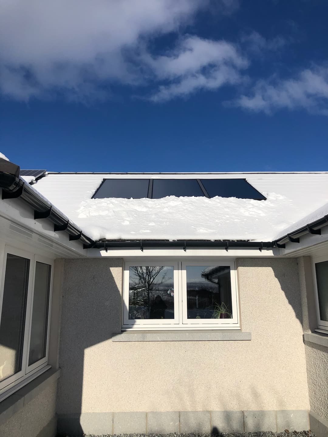Solar thermal panel on a roof in bright winter sun