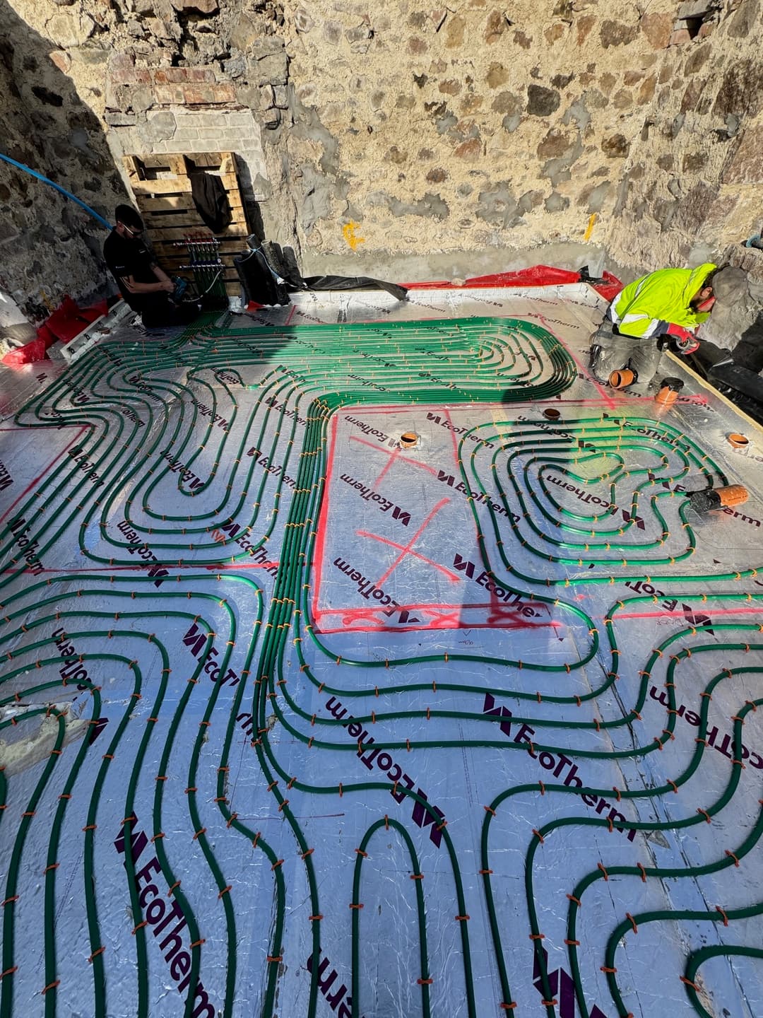 Underfloor heating loops being installed